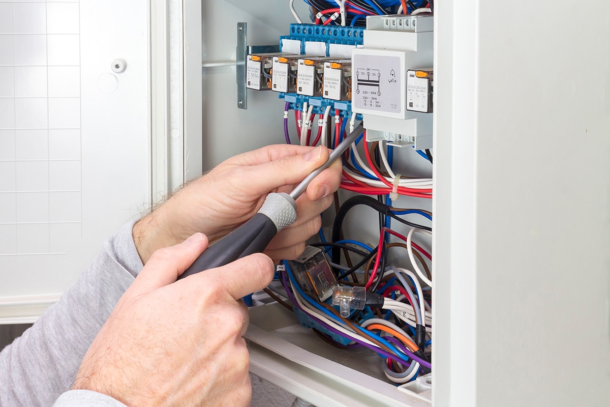 Electrician at work on an electrical panel