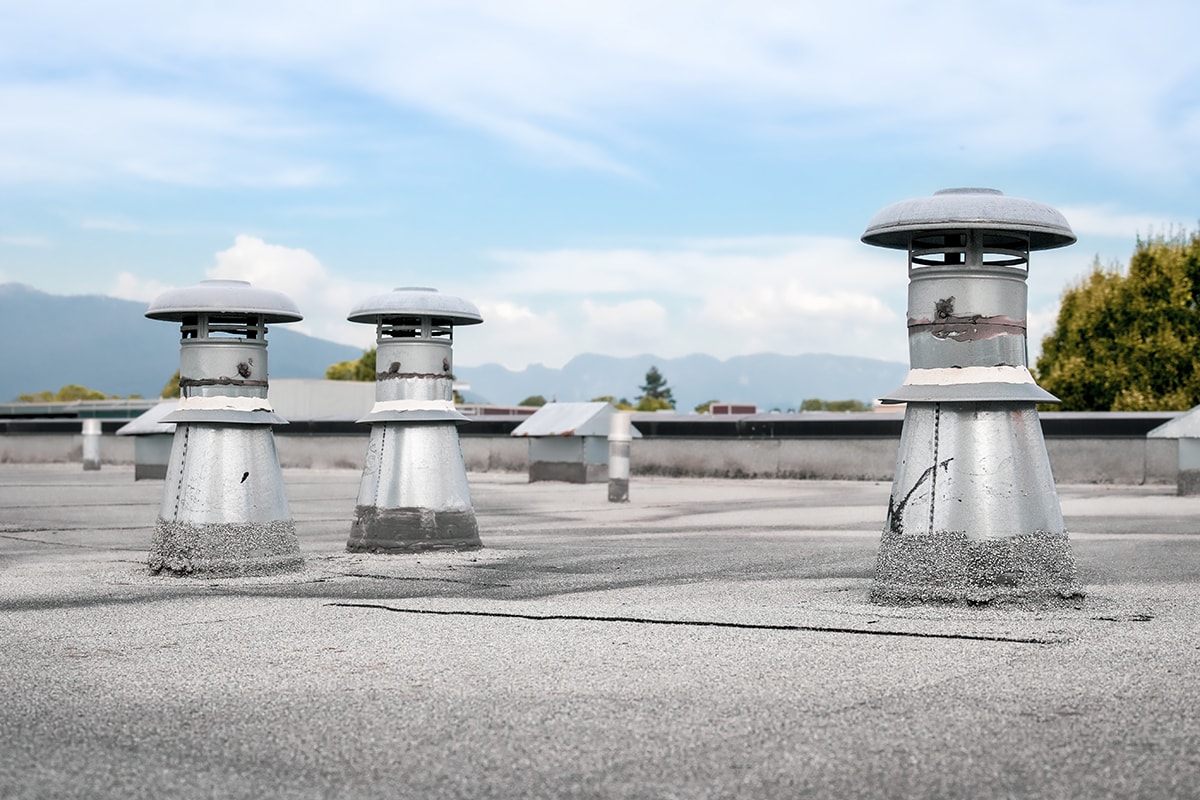 Flat roof vents on building with 2-ply SBS or modified bitumen roofing system