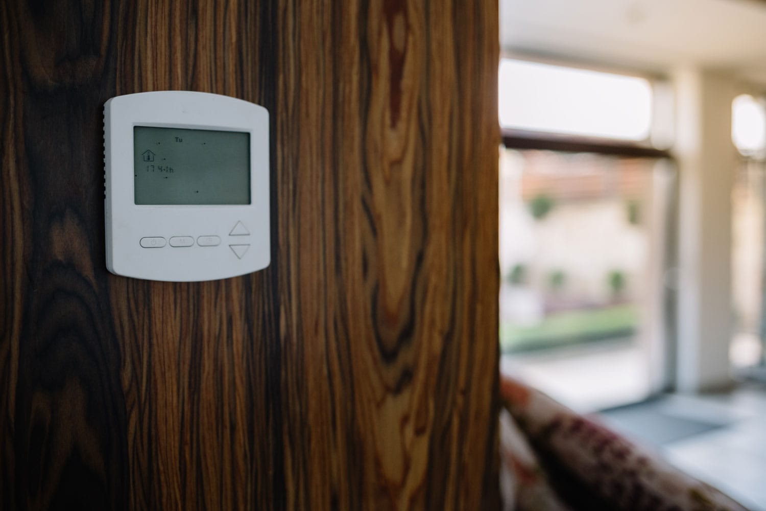 Programmable thermostat installed in the living room wall